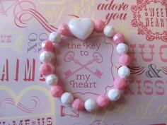 This is a Valentine Heart Beaded Bracelet. It has a white pearl heart pony bead in the middle. It has white and pink solid 8mm faceted beads. It was made with .8mm sturdy stretch string. I tie it several times to prevent breakage. It fits girls ages 5-10. It stretches to fit on the wrist. It would make a cute gift for a little girl for Valentine's Day. It would make a cute gift for a little girl's Birthday. All items are ready to be shipped I do combined shipping. Items ship in 2-5 business days Cute Heart Bracelet With Round Beads For Valentine's Day, Cute Heart-shaped Beaded Bracelets For Valentine's Day, Cute Heart Beaded Bracelets For Valentine's Day, Cute Heart Beads Beaded Bracelets For Valentine's Day, Cute Beaded Heart Bracelet For Valentine's Day, White Heart-shaped Stretch Bracelet For Valentine's Day, Cute Valentine's Day Stretch Bracelet With Round Beads, White Heart Stretch Bracelet For Valentine's Day, Cute Heart Beads Friendship Bracelets For Valentine's Day