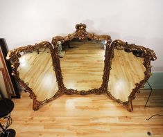 three mirrors sitting on top of a hard wood floor