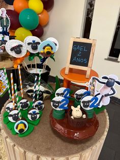 a table topped with cupcakes and cake toppers