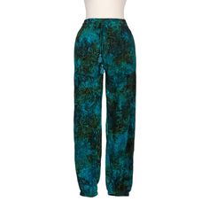 With their relaxed fit, elastic waist, and pretty leaf print, Galuh Kenanga's jogger pants are as comfortable as they are stylish. A hand-stamped batik motif in teal, turquoise, and soft amber adds to their beauty. In-seam pockets and a tasseled drawstring at the waist are thoughtful details. Green Harem Pants With Elastic Waistband, Green Relaxed Fit Harem Pants With Elastic Waistband, Green Cargo Pants With Elastic Waistband For Loungewear, Casual Turquoise Pants, Batik Pants, Batik Motif, Forest Canopy, Pretty Leaf, White Linen Pants