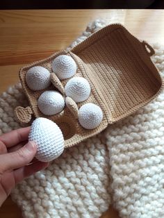 a knitted dishcloth with white balls in it and a crochet tray