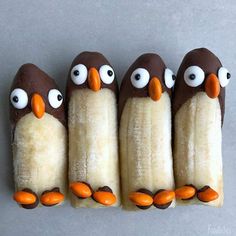 five bananas with googly eyes are arranged in the shape of penguins on top of each other