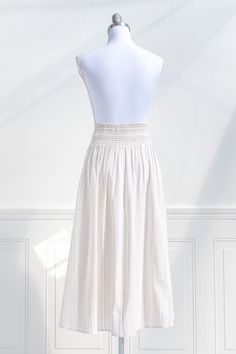 A must-have in the vintage-inspired wardrobe, the Sasha midi skirt in cream striped cotton features a faux button front, a fitted high waist, and a smocked elastic back for a comfortable fit. Perfectly paired with a knit top and ballet flats for a retro springtime look! . Details: S: Waist 26"-30", Length 33" M: Waist 28"-32", Length 33.5" L: Waist 30"-34", Length 34" Elastic Back Waistline Unlined Material: 100% Cotton Care: Hand Wash Cold / Hang Dry Imported Ships in 1 to 2 Business Days Free