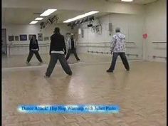 several people are dancing in an empty room