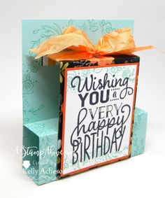 a birthday card in a box with orange ribbon on it and the words, wishing you a very happy birthday