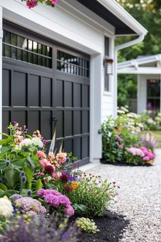 the flowers are blooming in front of the garage