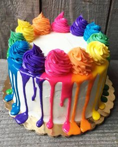 the cake is decorated with rainbow icing and has been bought for $ 3 99