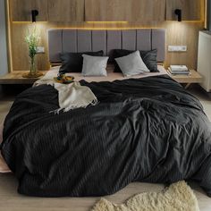 a large bed sitting in a bedroom next to a wooden headboard and night stand