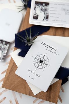 a passport sitting on top of a wooden table next to other papers and envelopes