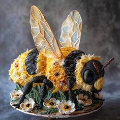 a cake made to look like a bee sitting on top of flowers