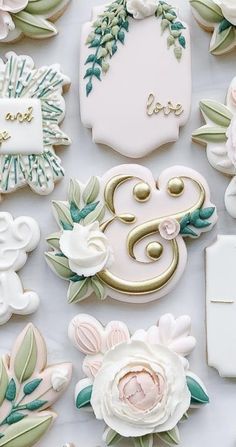 many decorated cookies with flowers and leaves on them