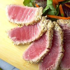 sliced up meat and vegetables on a cutting board