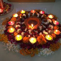 there are many lit candles in the center of this flower arrangement