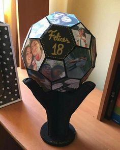 a table topped with a vase filled with pictures