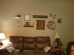 a living room with two couches and some decorations on the wall above them,