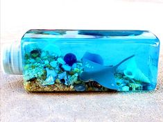 a bottle filled with sand and sea animals