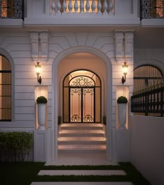 an entrance to a white house at night