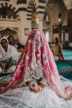 an instagram with a woman dressed in a pink and white outfit sitting on the floor