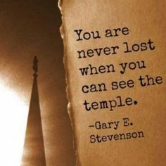 an old piece of paper with a quote on it next to a light bulb that reads, you are never lost when you can see the temple