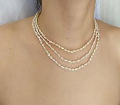 Elegant three strand beaded necklace handmade with 4 mm Freshwater Pearls.  925 Sterling Silver clasp.  Length: shortest strand 42.5 cm (16.7 in)Handcrafted – one of a kind.  Made in Greece.All items are delivered ready for gift-giving. Please don’t hesitate to contact me if you have any questions regarding this item. I’ll be happy to assist you.Thank you for visiting my shop. View additional designs herehttps://www.etsy.com/shop/ChrissilatoNOTE: Photos are not actual size. Images may have been Elegant Multi-strand Necklace With Tiny Beads, Multi-strand Faceted Beads Pearl Necklace As Gift, Silver Multi-strand Pearl Necklace, Three Strand Pearl Necklace, White Multi-strand Pearl Drop Necklace, Classic Pearl White Multi-strand Necklaces, Classic Multi-strand Pearl White Necklace, Link Necklace, Gold Plated Sterling Silver