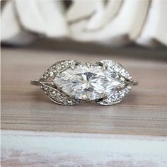 a diamond ring sitting on top of a wooden table