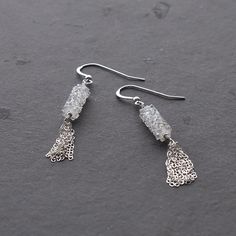 Make a statement with these stunning sparkly silver tassel earrings. Pair these beauties with leather pants and a flowy tank top for an edgy look. Want a more pulled together look? Find the matching necklace here. Details The Swarovski Crystal tube is 15mm long. The tassel is 0.5" long. A silver bead accents the ear wire Because the ear wires are sterling silver, they are nickel free and hypoallergenic. Total length of the earrings is slightly shorter than 2" long. Materials Sterling silver flat Trendy Silver Tassel Earrings For Party, Silver Tassel Earrings For Evening, Silver Trendy Tassel Earrings For Party, Chic Silver Earrings For Night Out, Silver Tassel Earrings For Party, Chic Silver Jewelry With Tassels, Chic Silver Tassel Earrings For Party, Trendy Silver Dangle Tassel Earrings, Silver Dangle Tassel Earrings