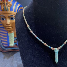 An ancient Egyptian 16.5 inch long necklace featuring tubular and circular faience beads in various shades of blue and tan.  Hanging from the necklace is a blue faience Wadj Sceptre amulet (rolled Papyrus scroll) which symbolized new life, regeneration, and was involved in the preservation of a mummy's body.  Circa 700 to 30 BC Shades Of Blue, Diamond Engagement