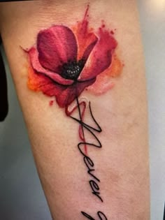 a watercolor tattoo with the word wonder written in cursive writing