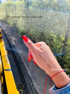 a woman's hand with a small tattoo on her left wrist and the words, mi tatatie mejor abreado