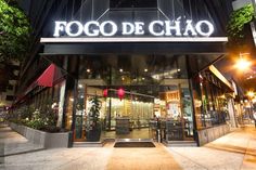 the entrance to a restaurant called fogo de chao at night with lights on