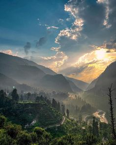 the sun shines brightly through the clouds over mountains and valleys in this scenic photo