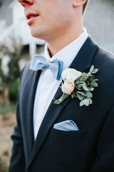 a man in a tuxedo with a boutonniere on his lapel