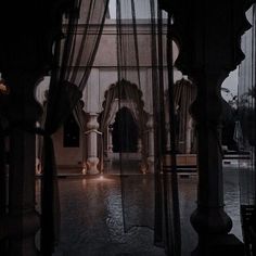 the inside of a building with sheer curtains