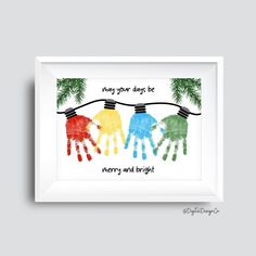 three handprints hanging on a clothes line with pine branches and the words, may your days be merry and bright