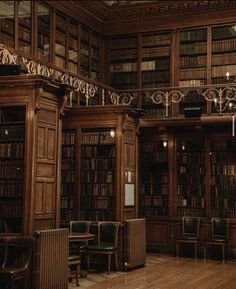 an old library filled with lots of wooden bookshelves and tables in front of them