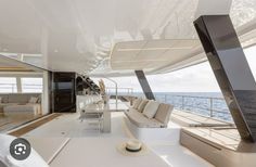 the interior of a large boat with couches and tables on it's deck