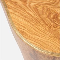 a wooden table with gold trimmings and wood grained edges on the top