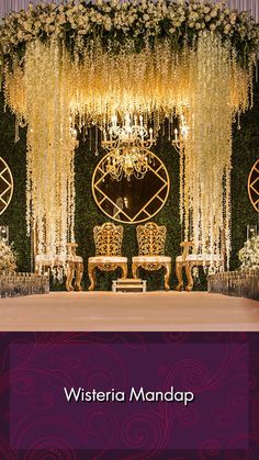 the wedding stage is decorated with flowers and chandeliers