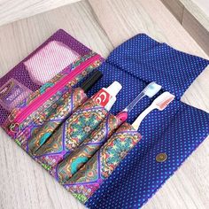 an open wallet with toothbrushes and other items in it sitting on a table