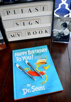 there is a happy birthday to you book next to the sign