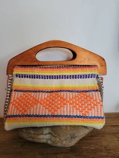 "Hand Embroidered Neon Vintage Style bag, Handmade in Beautiful Puebla, Mexico. The size of the bag is perfect for your personal stuff (cell phone, keys, wallet) looking super cute and unique. Measurements: Length: with the wood handle 7\" without the handle 5\" width:7\"" Retro Handmade Shoulder Bag For Beach, Retro Handmade Shoulder Bag For Vacation, Handmade Retro Shoulder Bag For Vacation, Handmade Hippie Rectangular Bag, Handmade Hippie Rectangular Shoulder Bag, Bohemian Handheld Satchel With Handles, Bohemian Handheld Shoulder Bag, Bohemian Handwoven Clutch Shoulder Bag, Bohemian Woven Clutch Shoulder Bag