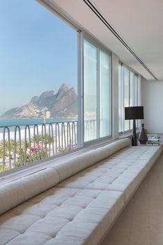 there is a large window with a view of the beach and mountains in the background