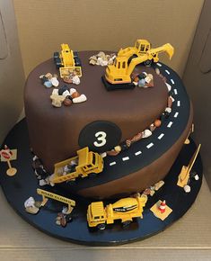 a birthday cake with construction vehicles on it