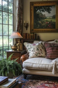 a living room filled with furniture and a painting hanging on the wall above it's windows