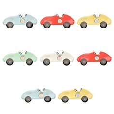 a group of toy cars sitting next to each other on top of a white surface