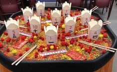 a table topped with lots of paper cups and chopsticks