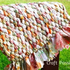 a blanket draped over a wooden post in the grass