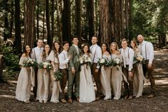 a group of people standing next to each other in the woods