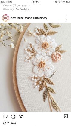 a close up of a embroidery on a hoop with flowers