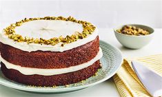 a cake with white frosting and sprinkles sitting on top of a plate